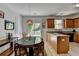 Open kitchen with granite countertops, stainless steel appliances, and a breakfast area at 1213 Harris Commons Place, Roswell, GA 30076