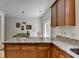 Kitchen features granite counters, wood cabinetry, and breakfast area at 1213 Harris Commons Place, Roswell, GA 30076