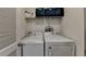 Efficient laundry room featuring side-by-side washer and dryer with shelf storage above at 1213 Harris Commons Place, Roswell, GA 30076