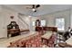 Bright living room featuring light wood floors, vintage furniture, and a staircase to the second floor at 1213 Harris Commons Place, Roswell, GA 30076