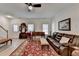Bright living room featuring light wood floors, vintage furniture, and a staircase to the second floor at 1213 Harris Commons Place, Roswell, GA 30076