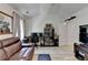 Vaulted living room with a brown leather sofa, workspace and entertainment center at 1213 Harris Commons Place, Roswell, GA 30076