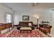 Living room showcasing hardwood-style flooring, a leather sofa, and elegant decor at 1213 Harris Commons Place, Roswell, GA 30076