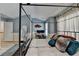 Comfortable main bedroom with four-poster bed, desk, and hardwood floors at 1213 Harris Commons Place, Roswell, GA 30076