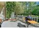 Inviting outdoor patio with a built-in grill, patio furniture, and privacy fence at 1213 Harris Commons Place, Roswell, GA 30076