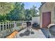 Outdoor patio with grilling station, patio seating, and views of backyard at 1213 Harris Commons Place, Roswell, GA 30076
