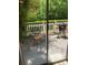 Cozy patio with grill, bench, and two chairs surrounded by a privacy fence and greenery at 1213 Harris Commons Place, Roswell, GA 30076