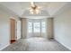 Spacious bedroom featuring plush carpeting, a ceiling fan, and a bay window offering plenty of natural light at 167 Fairview Oak Trl, Dallas, GA 30157