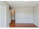 Bedroom features hardwood floors, neutral paint, closet, and an open doorway at 167 Fairview Oak Trl, Dallas, GA 30157