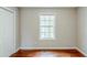 Cozy bedroom with hardwood floors, a window for natural light, and a double door closet at 167 Fairview Oak Trl, Dallas, GA 30157