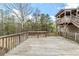 Expansive wooden deck with railing offers serene views of the surrounding nature at 167 Fairview Oak Trl, Dallas, GA 30157