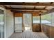 View of the wooden deck with wood railings, exposed rafter ceiling, and steps leading to the backyard at 167 Fairview Oak Trl, Dallas, GA 30157