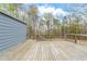 Large wooden deck with surrounding trees, perfect for outdoor entertaining and relaxation at 167 Fairview Oak Trl, Dallas, GA 30157