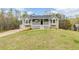 Charming home featuring a welcoming front porch and well-maintained lawn at 167 Fairview Oak Trl, Dallas, GA 30157