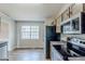 Open kitchen featuring stainless steel appliances and laminate flooring at 167 Fairview Oak Trl, Dallas, GA 30157