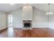 Cozy living room features vaulted ceiling, fireplace with stone hearth, and hardwood floors at 167 Fairview Oak Trl, Dallas, GA 30157