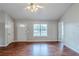 Bright living room with a large window, laminate floors, and fresh paint at 167 Fairview Oak Trl, Dallas, GA 30157