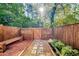 A beautiful fenced backyard with a stone pathway, bench, and attractive landscaping at 2622 Terrace Pkwy, Morrow, GA 30260