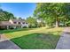 Expansive front yard and charming home exterior featuring lush greenery, mature trees, and classic architectural details at 2622 Terrace Pkwy, Morrow, GA 30260