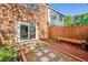 Private fenced-in brick patio with a wooden bench, stone pathway, and sliding glass door entrance at 2622 Terrace Pkwy, Morrow, GA 30260
