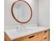 Bathroom featuring a wood vanity with a round mirror at 2622 Terrace Pkwy, Morrow, GA 30260