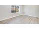 Bright bedroom featuring a large window and wood-look floors at 2622 Terrace Pkwy, Morrow, GA 30260