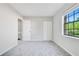 A cozy bedroom featuring plush carpeting, a closet, and a bright window with a pleasant outdoor view at 2622 Terrace Pkwy, Morrow, GA 30260