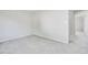This bedroom features neutral carpeting and paint, a closet, and an open doorway at 2622 Terrace Pkwy, Morrow, GA 30260