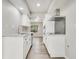 Bright kitchen with white cabinets, stainless steel appliances and a view to the backyard at 2622 Terrace Pkwy, Morrow, GA 30260