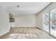 Open living area leading into the kitchen with bright light from sliding glass door at 2622 Terrace Pkwy, Morrow, GA 30260