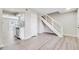 Open-concept living room with stainless steel appliances and modern staircase at 2622 Terrace Pkwy, Morrow, GA 30260