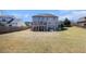 Expansive backyard features a large grassy area, deck, and mature trees, ideal for outdoor activities at 3308 Pate Rd, Snellville, GA 30078