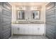 A stylish bathroom with double vanity, gray tile floors, and framed mirrors offers a modern and functional space at 3308 Pate Rd, Snellville, GA 30078