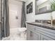 Cozy bathroom featuring a shower-tub, gray vanity, marble floors and modern finishes at 3308 Pate Rd, Snellville, GA 30078