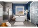 Luxurious bathroom with a freestanding tub, walk-in shower, modern tile, and stylish decor at 3308 Pate Rd, Snellville, GA 30078