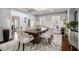 Spacious dining room with coffered ceilings, large wooden table, stylish seating, and modern decor at 3308 Pate Rd, Snellville, GA 30078
