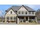 Stunning two-story home with a mix of stone and stucco, accented by black shutters and a gated entrance at 3308 Pate Rd, Snellville, GA 30078