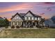 Elegant two-story home showcases manicured landscaping, stone accents, and a welcoming front porch at 3308 Pate Rd, Snellville, GA 30078