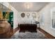 Sophisticated home office featuring a large desk, unique decor, hardwood floors, and custom built-ins at 3308 Pate Rd, Snellville, GA 30078