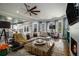 Spacious living room with a fireplace, modern decor, large windows, and a comfortable seating area at 3308 Pate Rd, Snellville, GA 30078