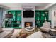 Bright living room with a modern fireplace, custom shelving, stylish furnishings, and a unique coffee table at 3308 Pate Rd, Snellville, GA 30078