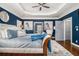 Beautiful main bedroom featuring a tray ceiling, sitting area, and hardwood floors at 3308 Pate Rd, Snellville, GA 30078