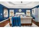 Spacious main bedroom with blue walls, tray ceiling, sitting area, and hardwood floors at 3308 Pate Rd, Snellville, GA 30078