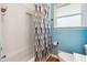 Cozy bathroom featuring tiled walls, modern toilet, and patterned shower curtain at 4290 Chestnut Grove Ln, Austell, GA 30106
