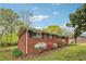 This brick home has black shutters, colorful landscaping, and a lush green lawn, presenting a welcoming curb appeal at 4290 Chestnut Grove Ln, Austell, GA 30106