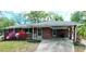 Inviting brick home featuring a covered carport and lush landscaping with vibrant azaleas in the front yard at 4290 Chestnut Grove Ln, Austell, GA 30106