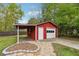 Red garage with a covered carport, a standard door, and a roll-up door at 4290 Chestnut Grove Ln, Austell, GA 30106