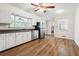 A bright kitchen features white cabinets, stainless steel appliances, and hardwood floors, blending functionality with style at 4290 Chestnut Grove Ln, Austell, GA 30106