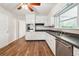 Bright kitchen featuring stainless steel appliances, white cabinetry, and hardwood floors at 4290 Chestnut Grove Ln, Austell, GA 30106