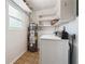 Laundry room featuring a washing machine, shelving, and a water heater at 4290 Chestnut Grove Ln, Austell, GA 30106